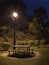 Night scenery of bench, picnic table and street light in park