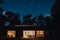 Night scenery of light house surrounded with trees under a starry sky