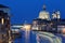 Night scenery of romantic Venice in blue twilight, with light trails of ferries, boats & ships cruising on the Grand Canal