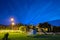 Night shining clouds over the wooden choldren house and a garden playground. Poland