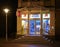 Night shot of the brightly lit shop window of a pharmacy.