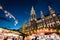 Night shot of Christmas markets at Rathausplatz, lighted town hall, christmas tent in the foreground