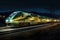 night shot of high-speed train lit up with streaks of light