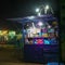 Night shot of an illuminated cigarette stall on the outskirts of town