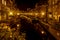 A night shot from the Sint Jansbrug on the Oude Rijn with numerous boats and illuminated old canal-side houses, Leiden, the Nether