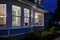 night shot of victorian homes bay window with indoor lighting