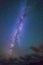 Night sky with clouds and milky way and trees in summer time