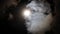 Night sky with shining full moon behind moving dramatic clouds. Time lapse