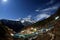 Night sky and stars passing by behind mountain Kongde Ri, Namche Bazaar village. Nepal