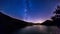 Night sky stars timelapse. milky way on mountain lake landscape