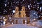 Night snowfall on empty Spanish square and steps in Rome with church Trinita di Monti in background, Italy. Piazza di Spagna