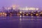 Night snowy foggy Prague Lesser Town with Charles Bridge and gothic Castle in the Snowstorm, Czech republic