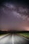 Night Starry Sky Above Country Asphalt Road In Countryside And Green Field. Night View Of Natural Glowing Stars And
