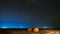 Night Starry Sky Above Haystacks In Summer Agricultural Field. Night Stars Above Rural Landscape With Hay Bales After