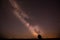 Night Starry Sky And Lonely Tree In Meadow. Glowing Stars And Wo