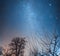 Night starry winter sky over the village. Astro landscape