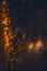 Night street blurred with decorative lights bokeh from garland, Christmas eve time morning, unfocused vertical abstract photo