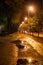 Night street with puddles in Riga under the bright lights
