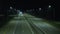 Night suburban highway with cars and lights in a slight out of focus