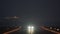 Night takeoff of an airplane against the background of a passing cruise ship