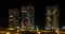 Night time lapse of Light in the windows of a multistory building with zoom. life in a big city