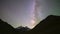 Night time-lapse video of the movement of the milky way over the silhouettes of the mountains. Space video galaxy view