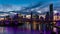 Night time panorama of Brisbane city with purple lights on Story Bridge