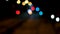 Night time urban scene out of focus coloured bokeh traffic lights from cars top view from a over passing bridge