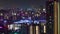 A night timelapse of building lights in Osaka telephoto shot zoom
