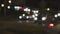 Night traffic lights. Defocused cars moving along in the light of carlights