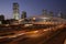 Night traffic in Tel Aviv. modern metal bridge in the city in the downtown over the highway and railway. concept of modern enginee