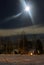 Night and train station covered with snow in the moonlight. Night city skyline.