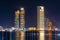 Night view of Abu Dhabi modern skyscrapers panorama. Luxury lifestyle hotels and business centers of United Arab Emirates.