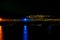 Night view of bay seawall backlights and far lights of the coast