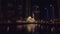 Night view on beautiful small mosque in Dubai Marina, view from floating pleasure boat