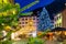 Night view of Brig street with Christmas tree on background of Alps, Switzerland