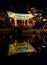 Night view of buddhist pavillion with water reflection