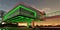 Night view of the cantilevered floor above the illuminated porch of the eco-friendly modern country mansion with glass facade at