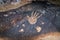 A night  view of a drawing depicting a handprint of a man carved in stone by a primitive man in the desert in southern Israel near