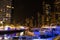 Night view of Dubai Marina skyscrapers and luxurious yachts at pier UAE