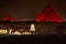 Night view on the enlighted Pyramids of Giza, Egypt