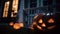 Night view of a halloween pumpkins nearby house in autumn