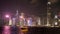 Night view of the IFC building and a cruise ferry on victoria harbour- as seen from tsim sha tsui promenade in hong kong