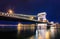 Night view of illuminated Budapest with Danube river, parliament, palace and bridge.