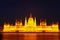 Night view of the illuminated building of the Hungarian Parliament in Budapest.