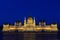 Night view of the illuminated building of the Hungarian Parliament in Budapest.