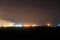 Night view of industrial district of the city and smoke pipes of factory