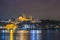 Night view of Istanbul cityscape  Suleymaniye Mosque Rustem Pasha Mosque with floating tourist boats in Bosphorus ,Istanbul