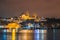 Night view of Istanbul cityscape Suleymaniye Mosque Rustem Pasha Mosque with floating tourist boats in Bosphorus ,Istanbul