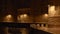 Night view of lanterns illuminating old houses, coastal road in Monopoli, Italy